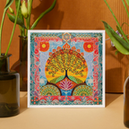 Colorful abstract art print of a tree with flowers on a wooden surface.