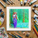 Colourful painting of a woman in a garden on a wooden surface with art supplies.