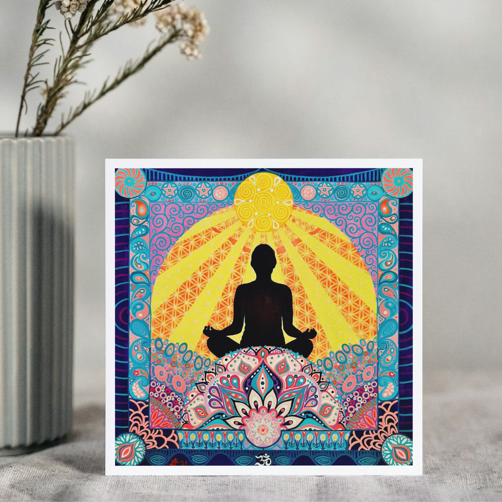 Colorful tapestry with a silhouette of a person meditating, placed on a surface with a vase and flowers in the background.