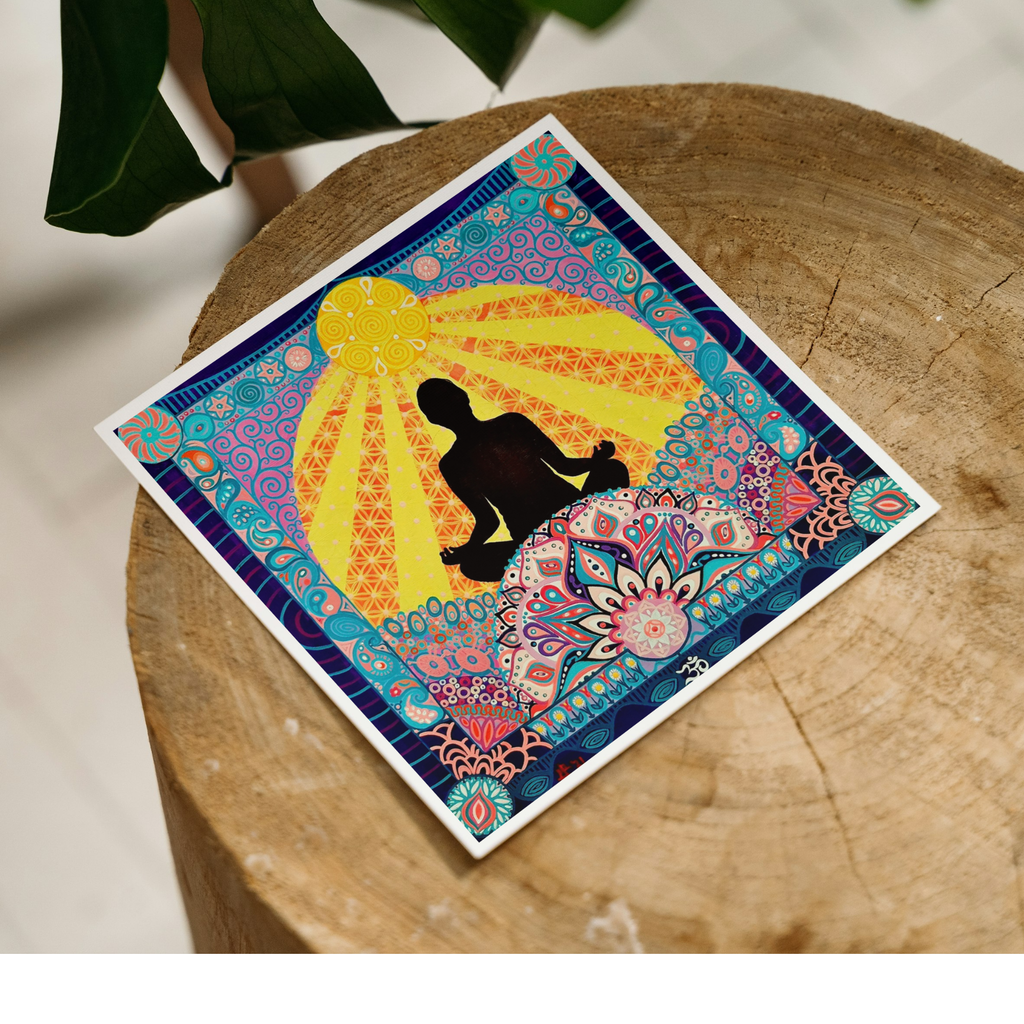 Colourful artwork with a silhouette of a yoga pose on a mandala background on a wooden surface