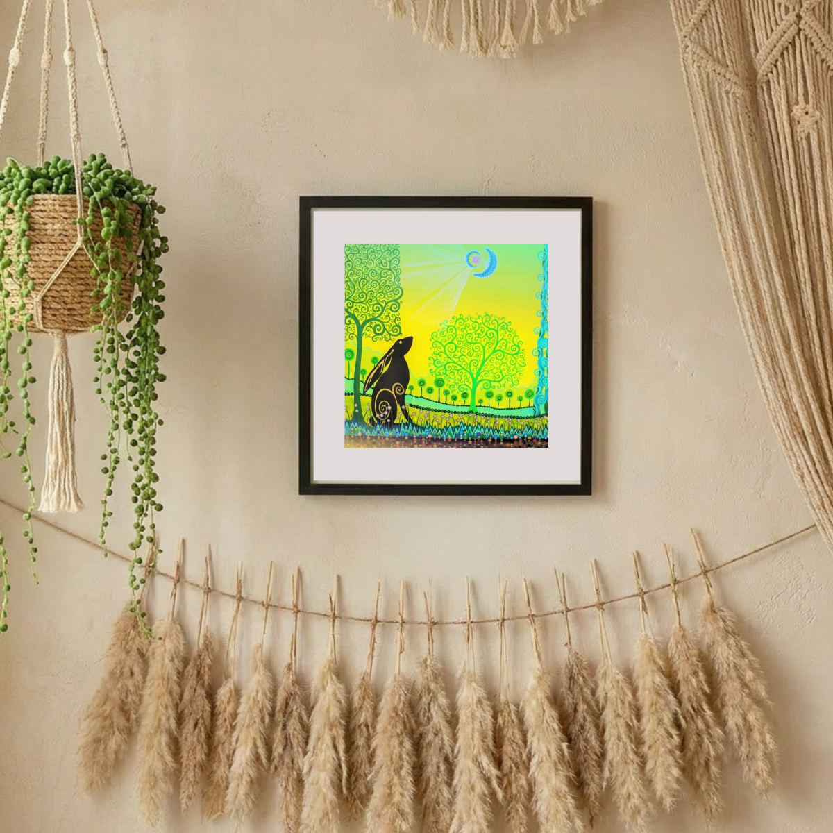 Framed artwork on a wall with decorative elements like potted plants and dried grasses.