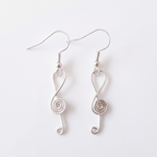 Silver music spiral earrings on a white background