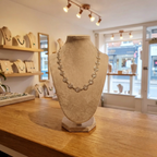 Necklace on a mannequin bust in a jewelry store setting
