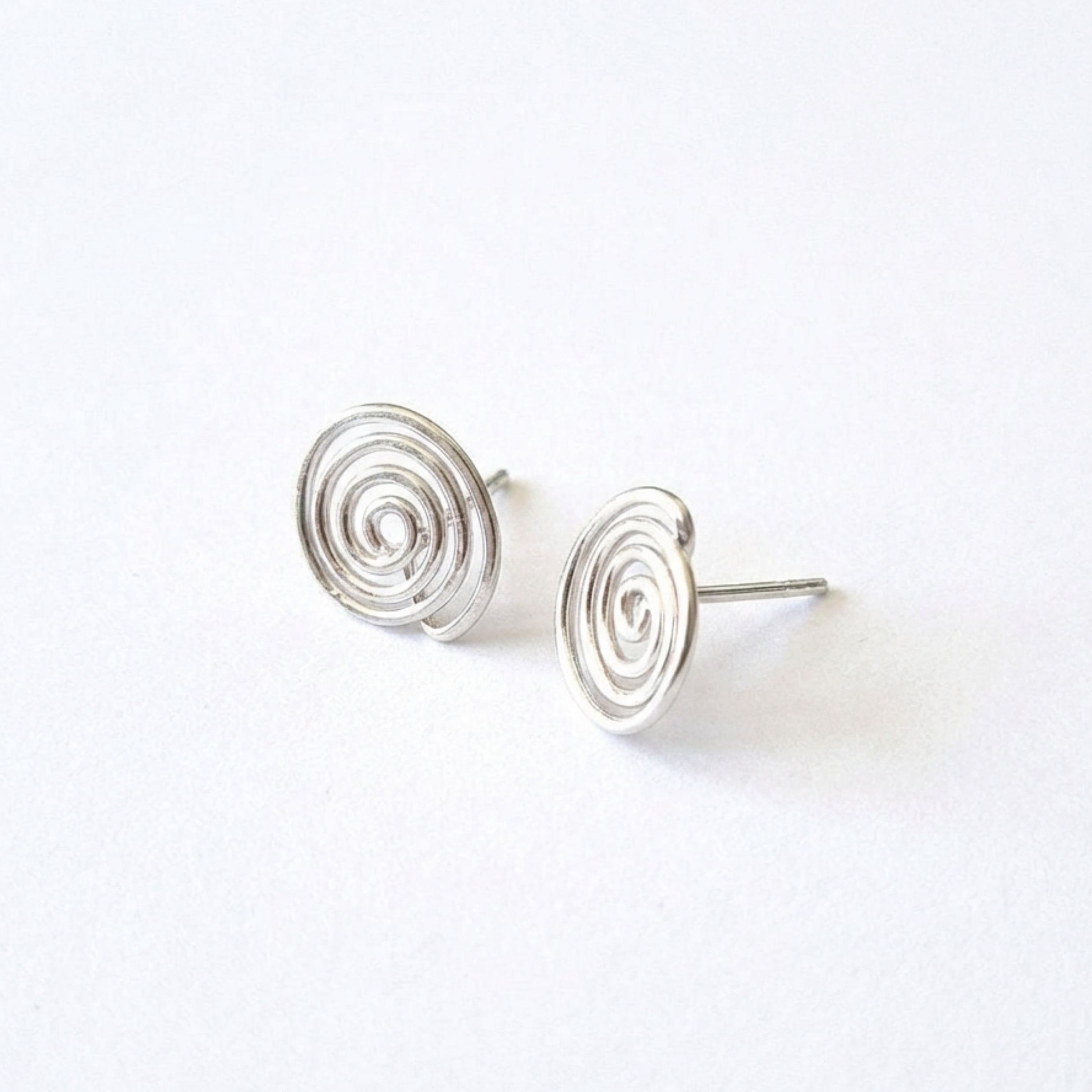 Silver spiral earrings on a white background