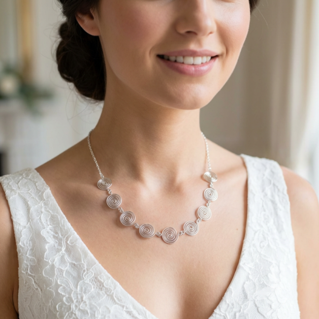 Woman wearing a white lace top and a decorative necklace with a blurred background