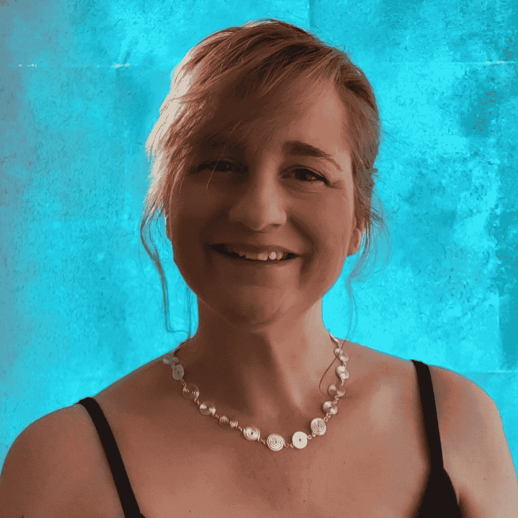 Woman wearing a silver spiral necklace against a blue background