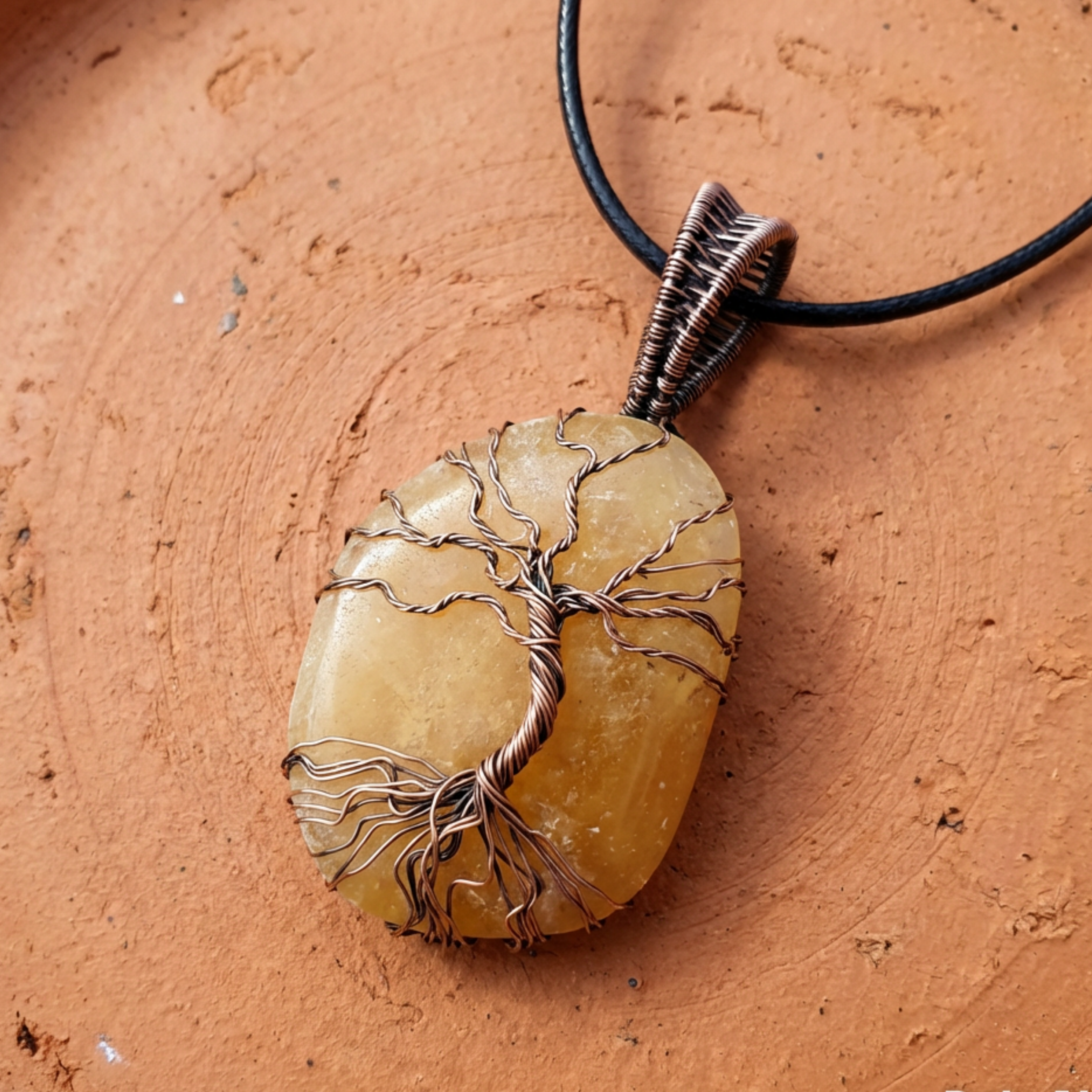 Pendant with tree design on a stone-like surface