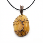 Orange Calcite stone pendant with copper tree of life detail on a white background