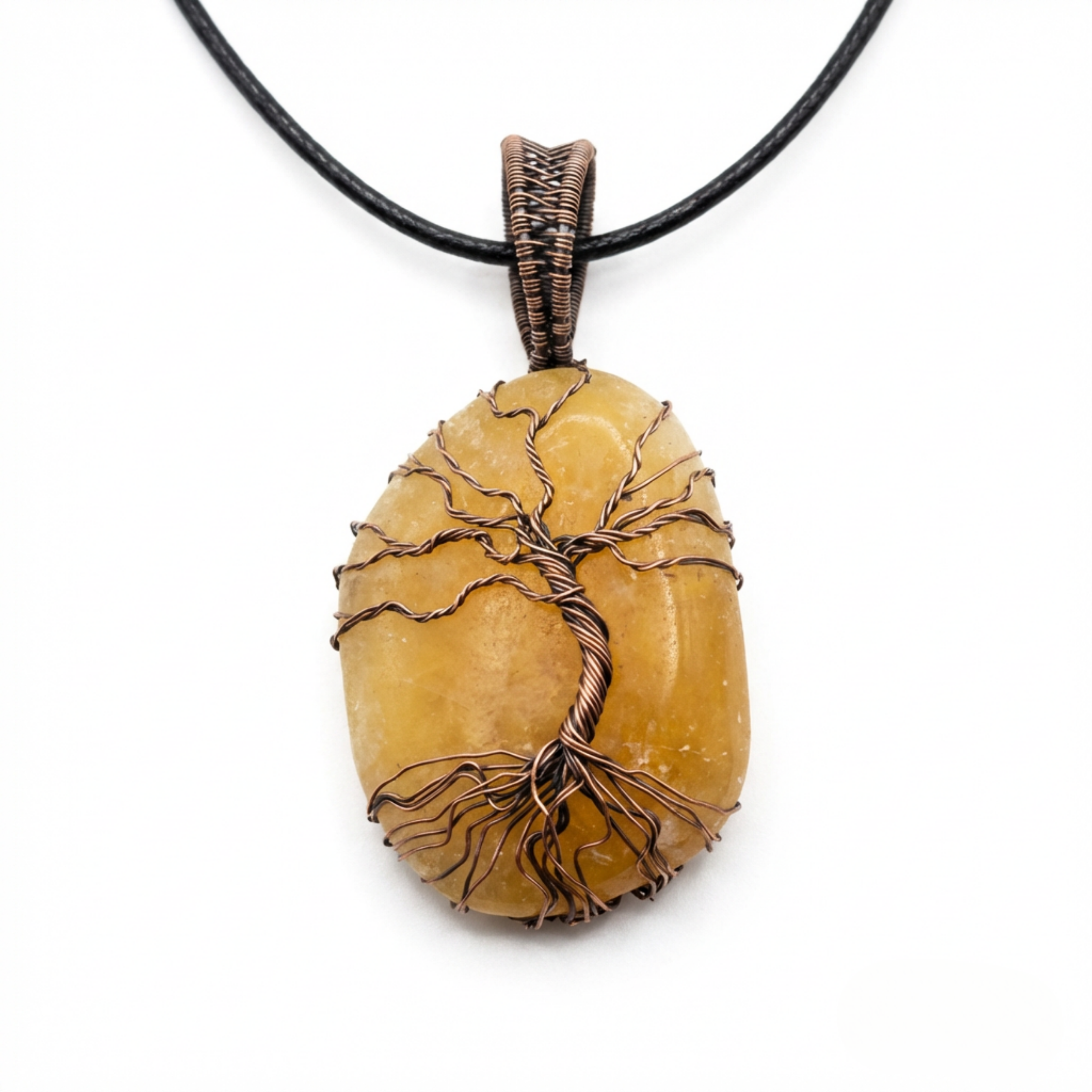 Orange Calcite stone pendant with copper tree of life detail on a white background