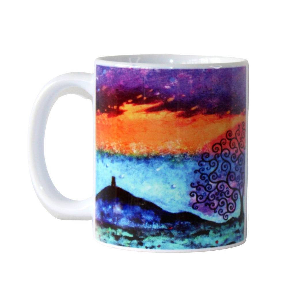 Mug with a colourful design of a sunset and silhouette of Glastonbury Tor on a white background