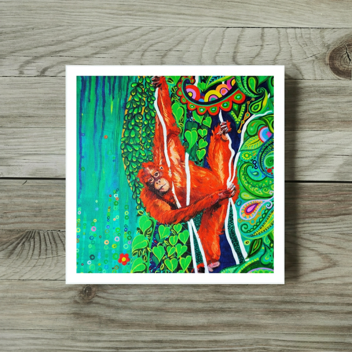 Colourful artwork of an orangutan on a wooden surface