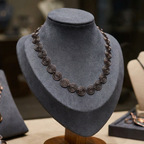 Copper Necklace on a grey mannequin bust with a blurred background