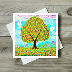 Colourful greeting card of the tree of life and peace doves painting on a wooden surface