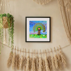 Framed artwork of a peacock tree of life on a wall with decorative elements like pampas grass and macrame.