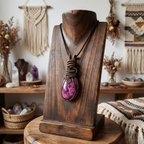 Necklace with a purple pendant on a wooden stand in a bohemian-style room.