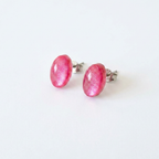 Pair of pink oval earrings on a white background