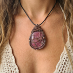 Model wearing a large pink gemstone copper pendant