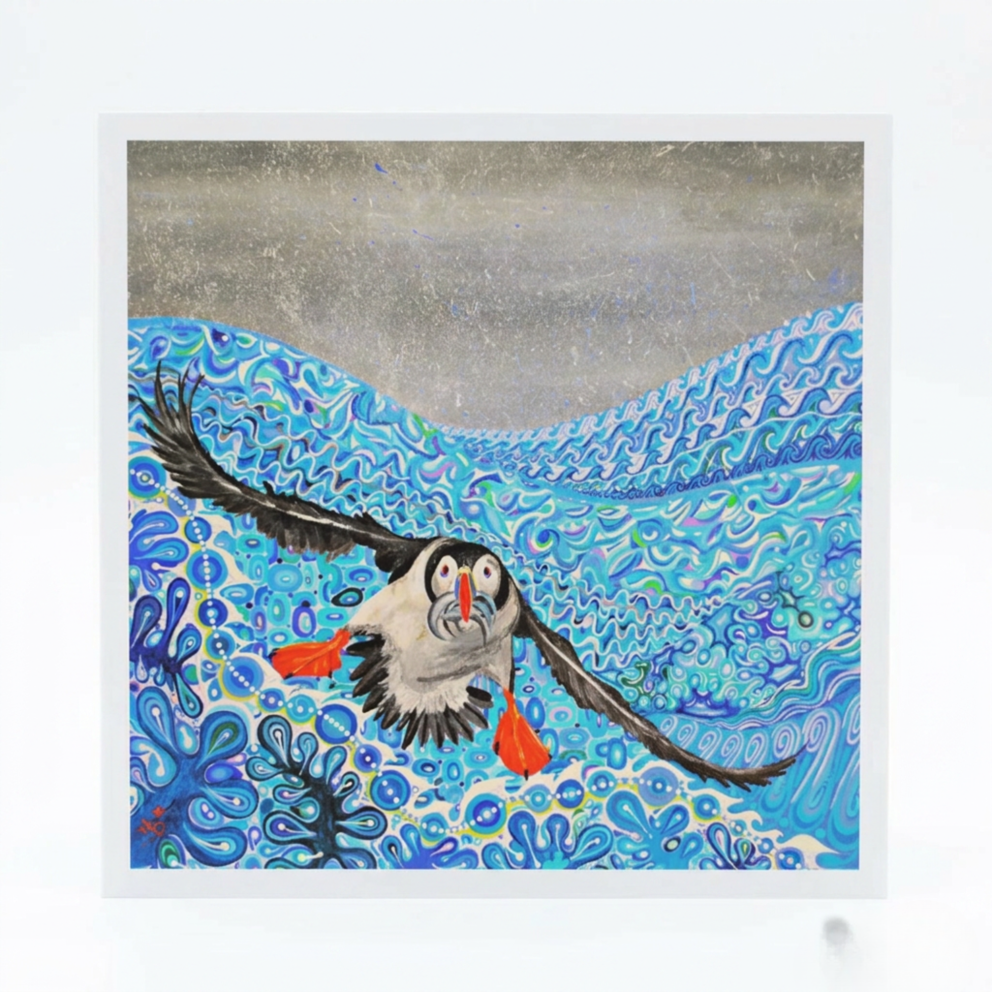 Illustration of a puffin flying over water with fish, framed by a white border.