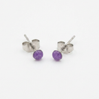 Purple stud earrings on a white background