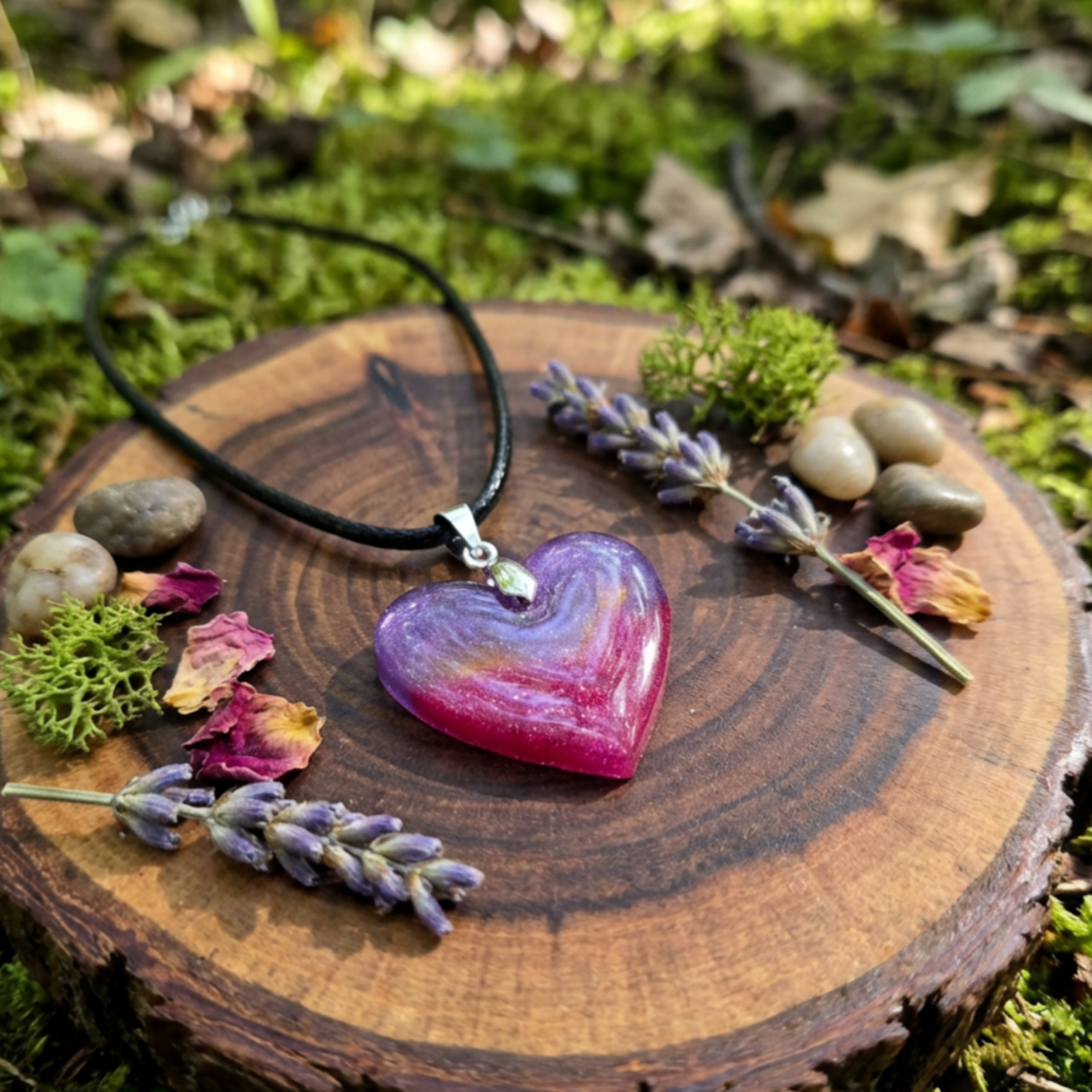 Purple and pink Heart pendant with a gold stripe on a wood slice with lavender and moss