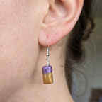Model wearing purple and gold rectangle drop earrings