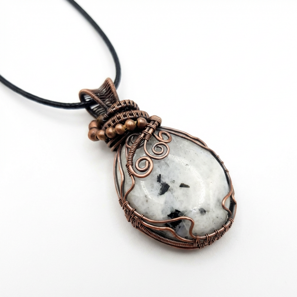 Necklace with a pendant featuring a white rainbow moonstone stone and copper wire wrapping on a white background