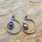 Rainbow hematite heart hoop copper earrings on light wood background, artisan boho jewellery UK