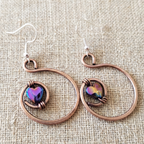 Rainbow hematite heart hoop copper earrings close-up, wire-encased hematite heart handmade UK