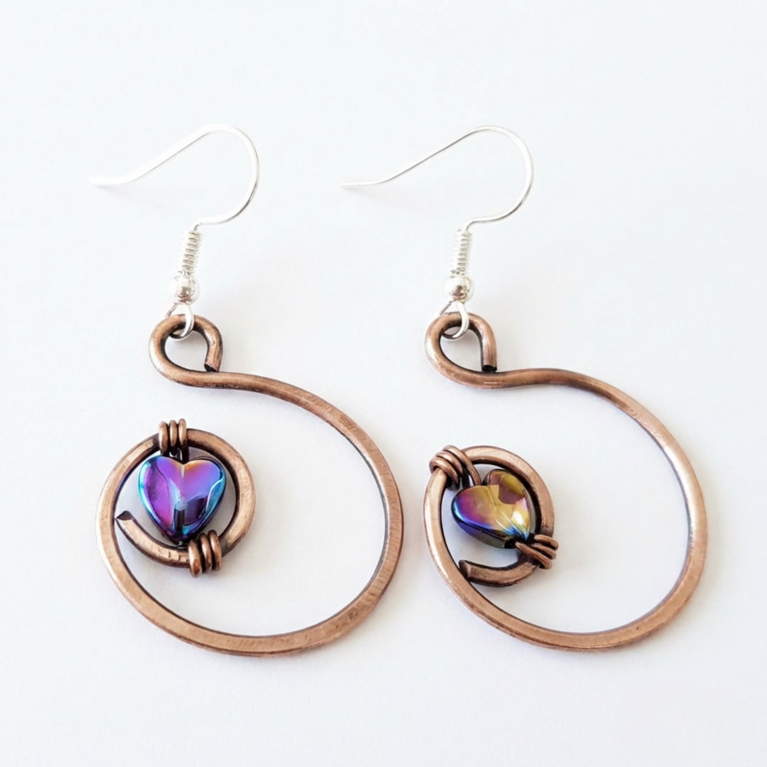 Rainbow hematite heart hoop copper earrings worn by model, rustic handmade jewellery UK