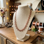 Necklace on a mannequin bust with a rustic background