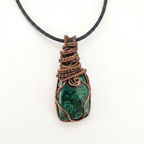 Necklace with a green stone pendant wrapped in copper wire on a white background