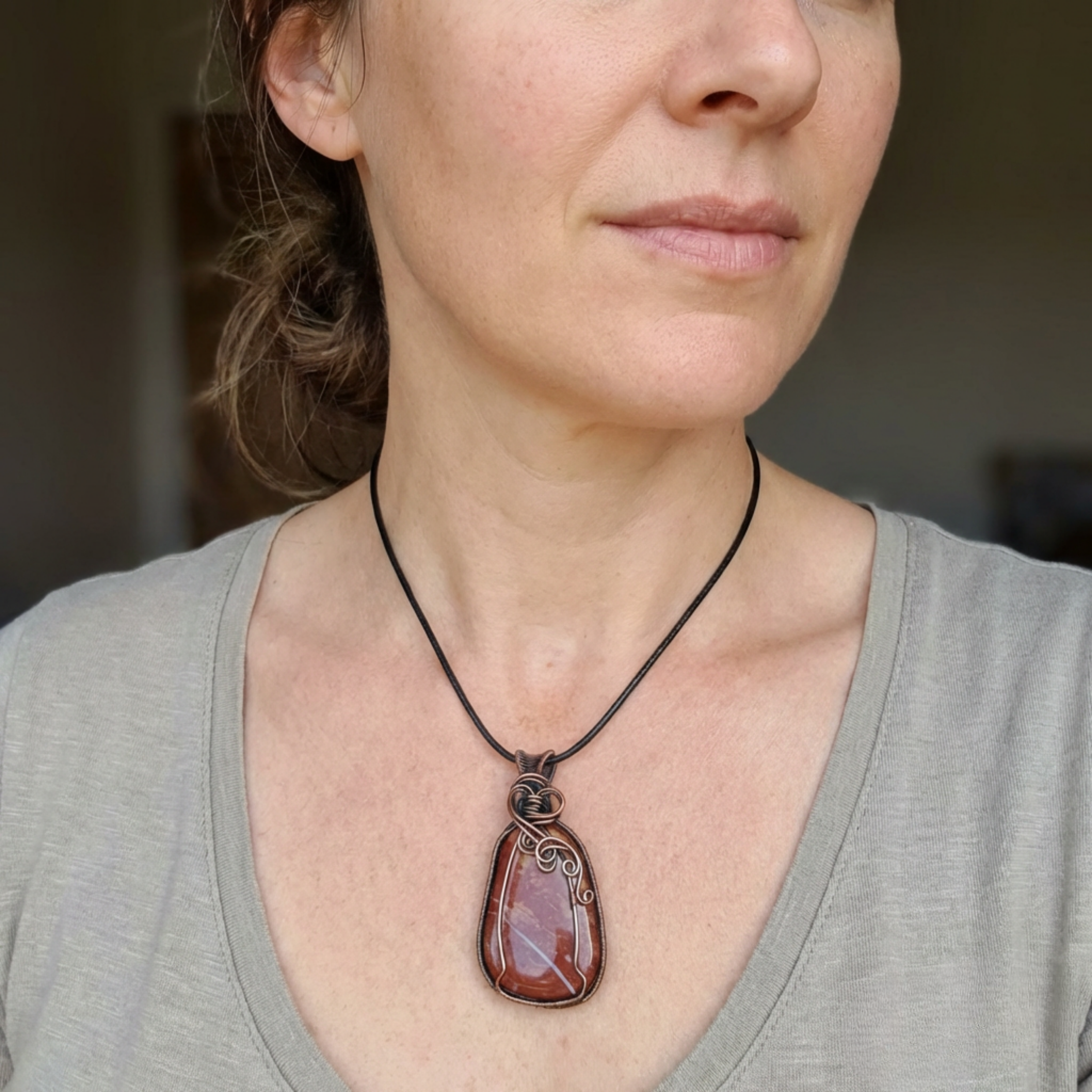 Woman wearing a necklace with a large pendant