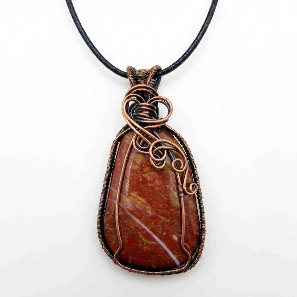 Brown stone pendant with copper wire wrapping on a black cord against a white background