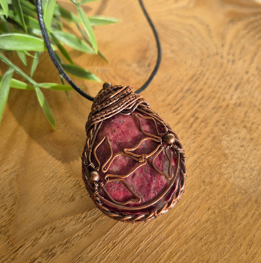 Floral details on a copper wire wrapped Rhodonite pendant