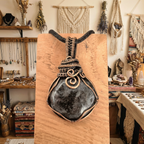 Decorative pendant on a wooden stand with a bohemian interior background
