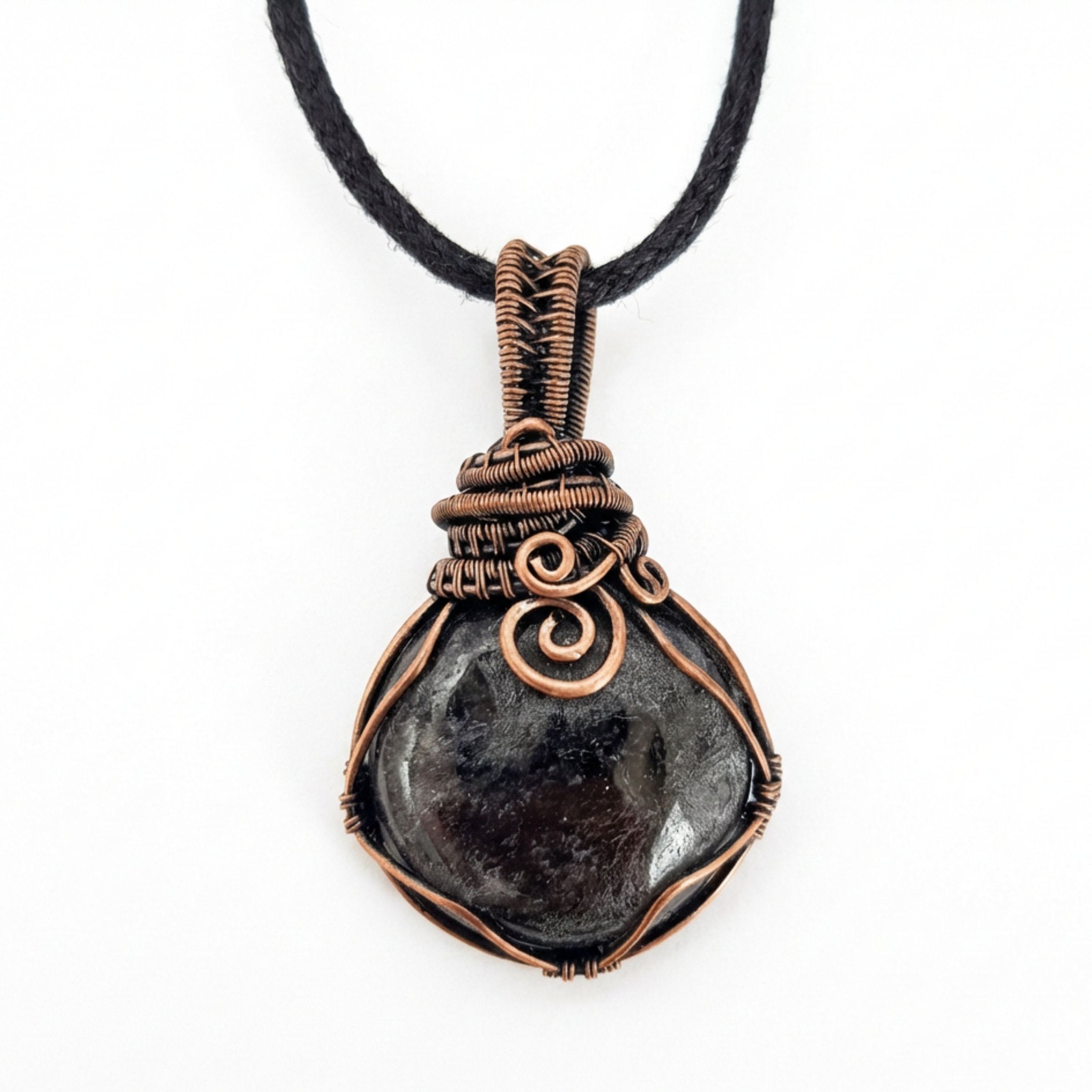 Necklace with a dark stone pendant wrapped in copper wire on a white background