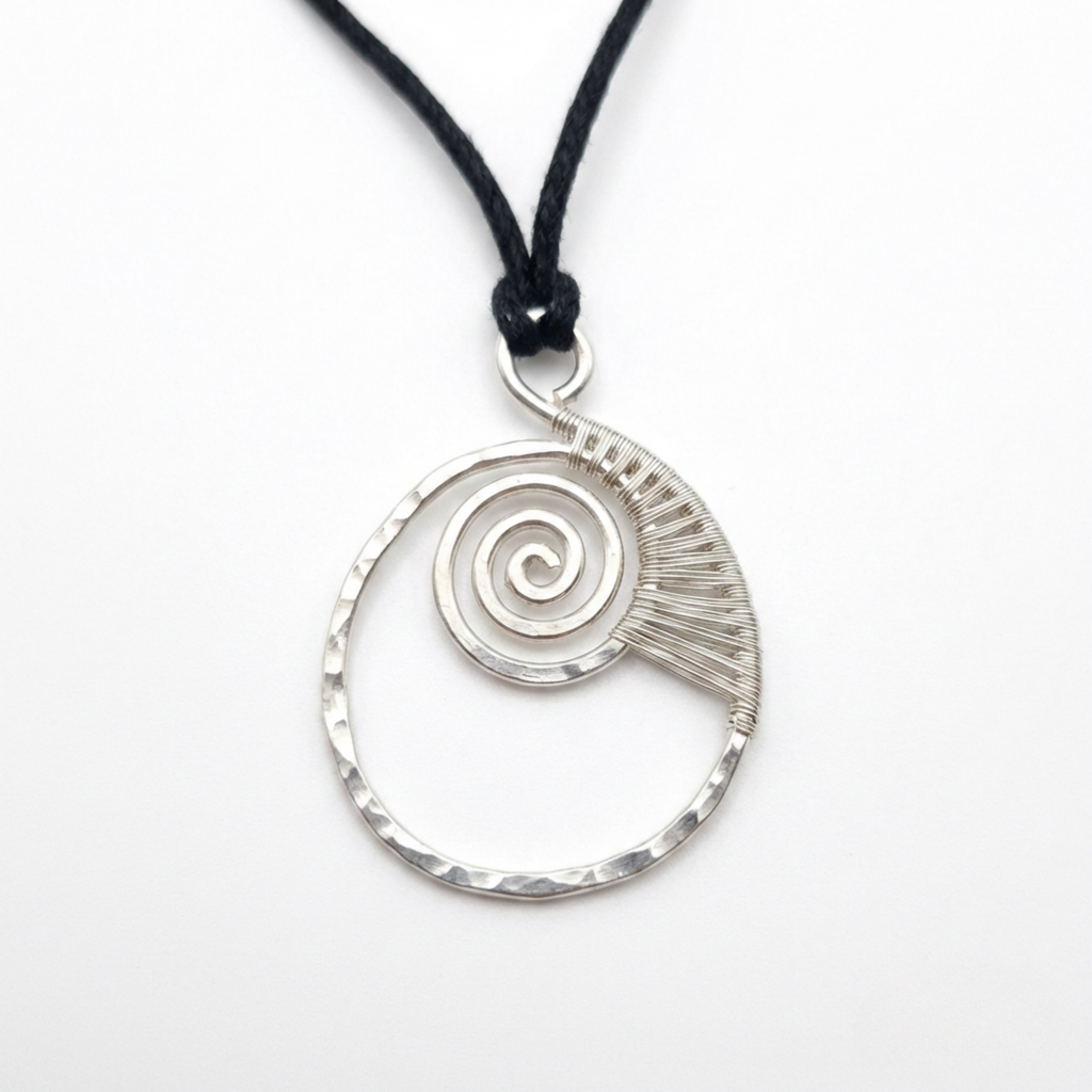 Silver spiral pendant on a black cord against a white background