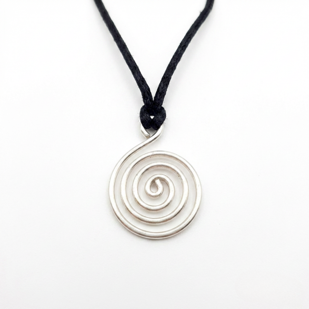 Silver spiral pendant on a black cord against a white background