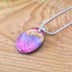 Colorful pendant necklace on a wooden surface