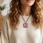 Person wearing a necklace with a colorful pendant, indoors.