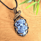 Necklace with a blue stone pendant on a wooden surface