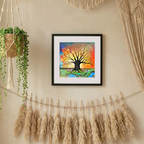 Framed colourful tree of life artwork on a wall with potted plants and decorative strings.