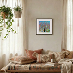 Cozy living room with patterned pillows, a colourful abstract Tree of Life painting, and plants.
