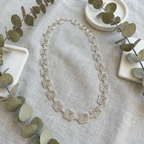 Detailed view of a geometric square Greek style chain necklace in silver
