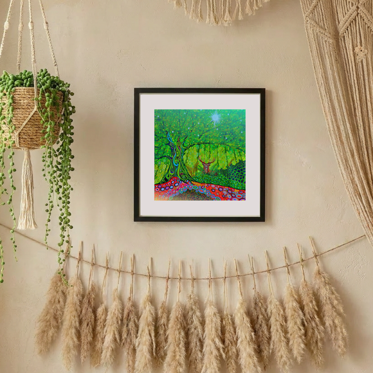 Framed artwork on a wall with decorative elements like pampas grass and macrame.