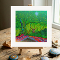 Colourful abstract artwork of a deer in a forest on a wooden easel.