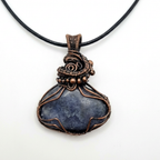 Necklace with a blue stone pendant and copper wire wrapping on a white background