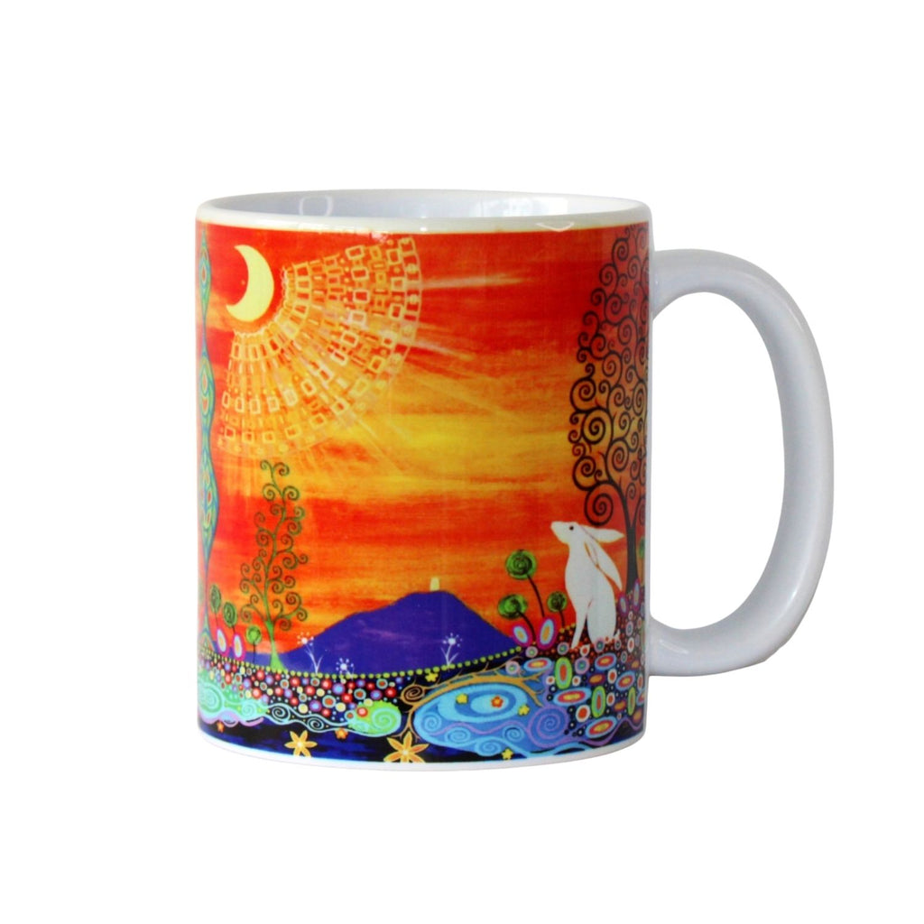 Colourful mug with artistic design of a hare, moon, Glastonbury Tor and sun on a white background