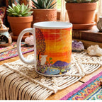 Colourful mug with artistic design on a textured surface with plants and books in the background