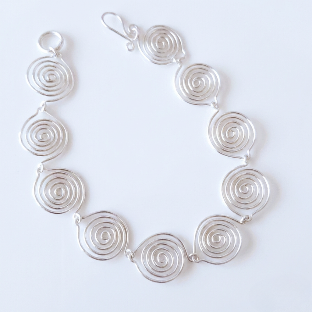 Silver spiral necklace on a white background